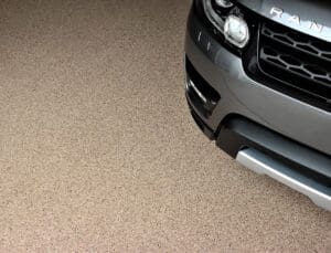 Range Rover SUV on a tan flake polyaspartic garage floor coating