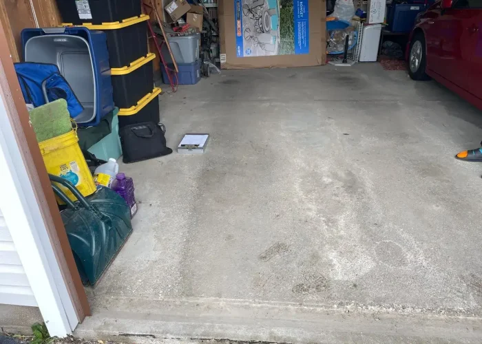 garage-floor-transformation-north-chili-ny Before garage floor coating showing worn concrete surface in Gates Chili and Rochester NY home
