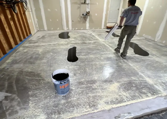 polyaspartic-floor-coating-north-chili-ny-finish Epoxy coating application process with crew installing base coat in Rochester Irondequoit and Greece NY